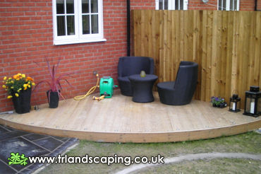Laid Decking Area and Grey Patio Slabbing